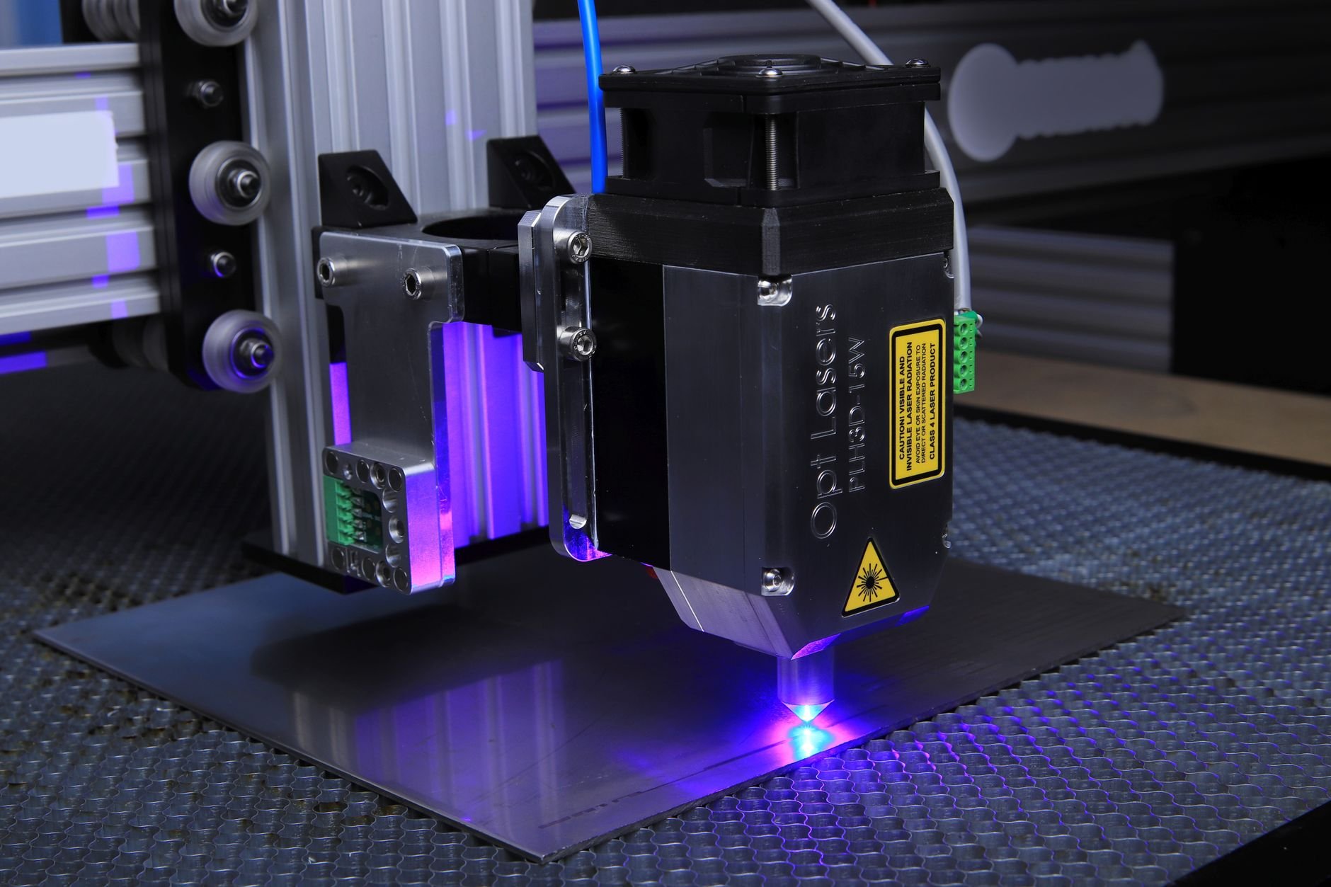 Close-up of a laser engraving machine operating on a metal surface